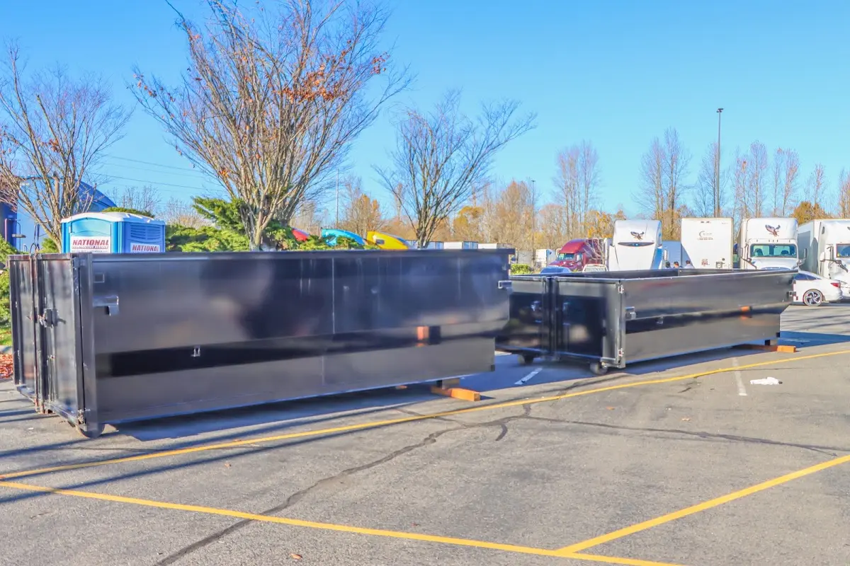 Professional dumpster rental service with roll-off container on residential driveway in Morristown